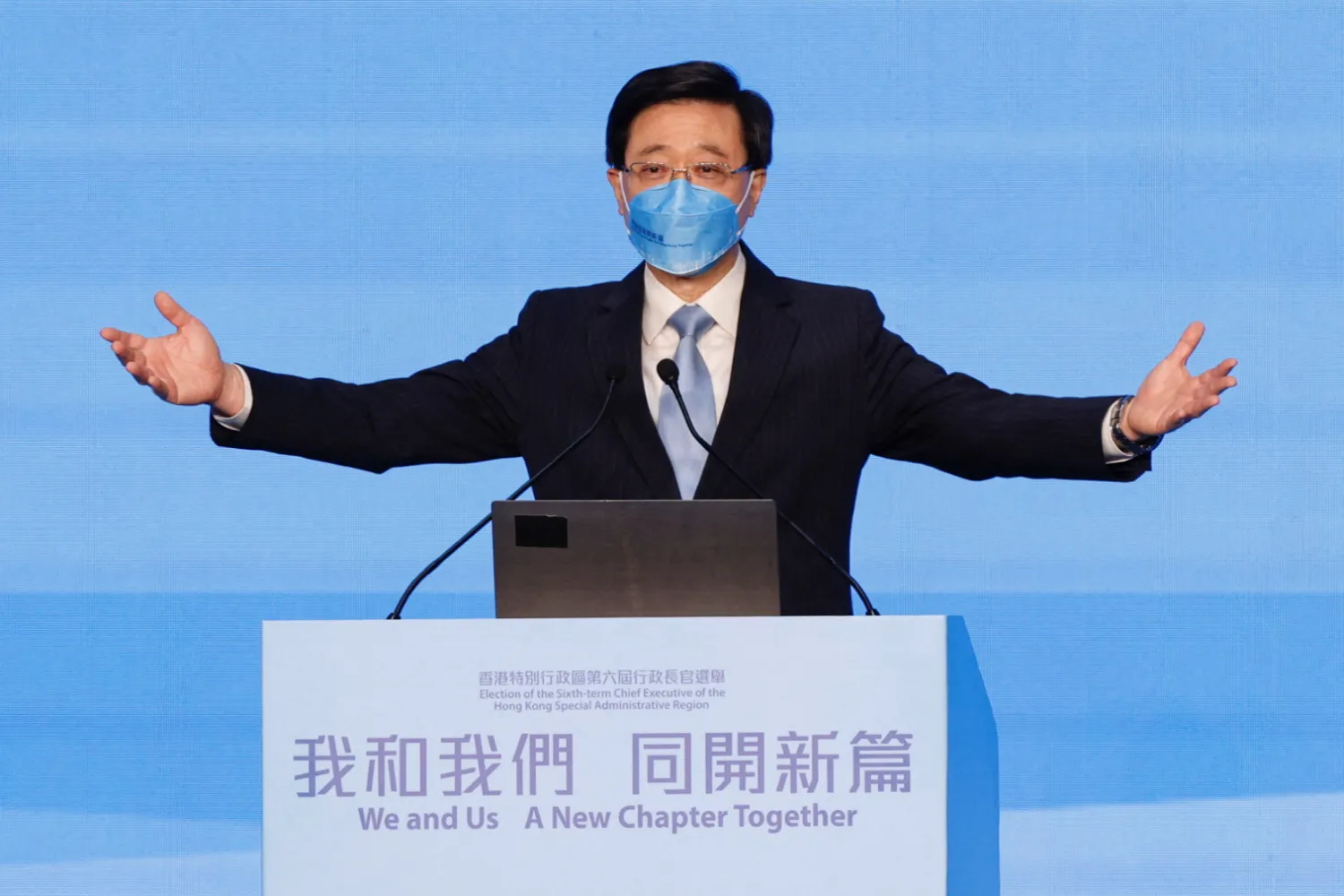 John Lee waves on stage after being elected as Hong Kong's Chief Executive, in Hong Kong, China, May 8, 2022. REUTERS/Tyrone Siu