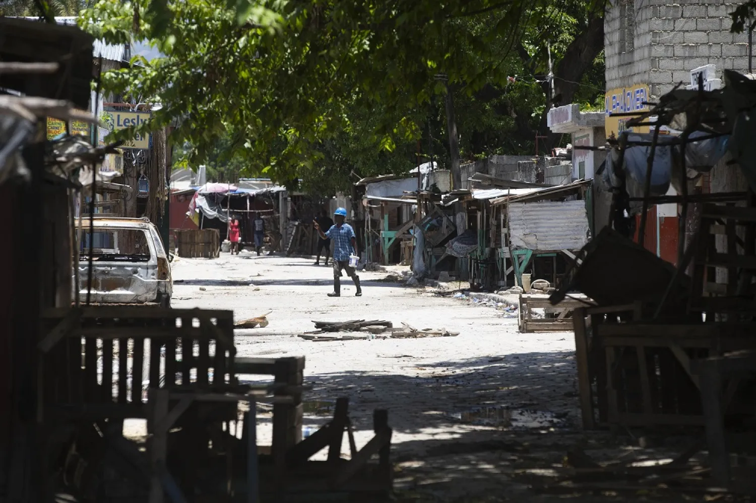 A man crosses a street barricaded during clashes between armed gangs in La Plaine neighborhood of Port-au-Prince, Haiti, Friday, May 6, 2022. (AP)
