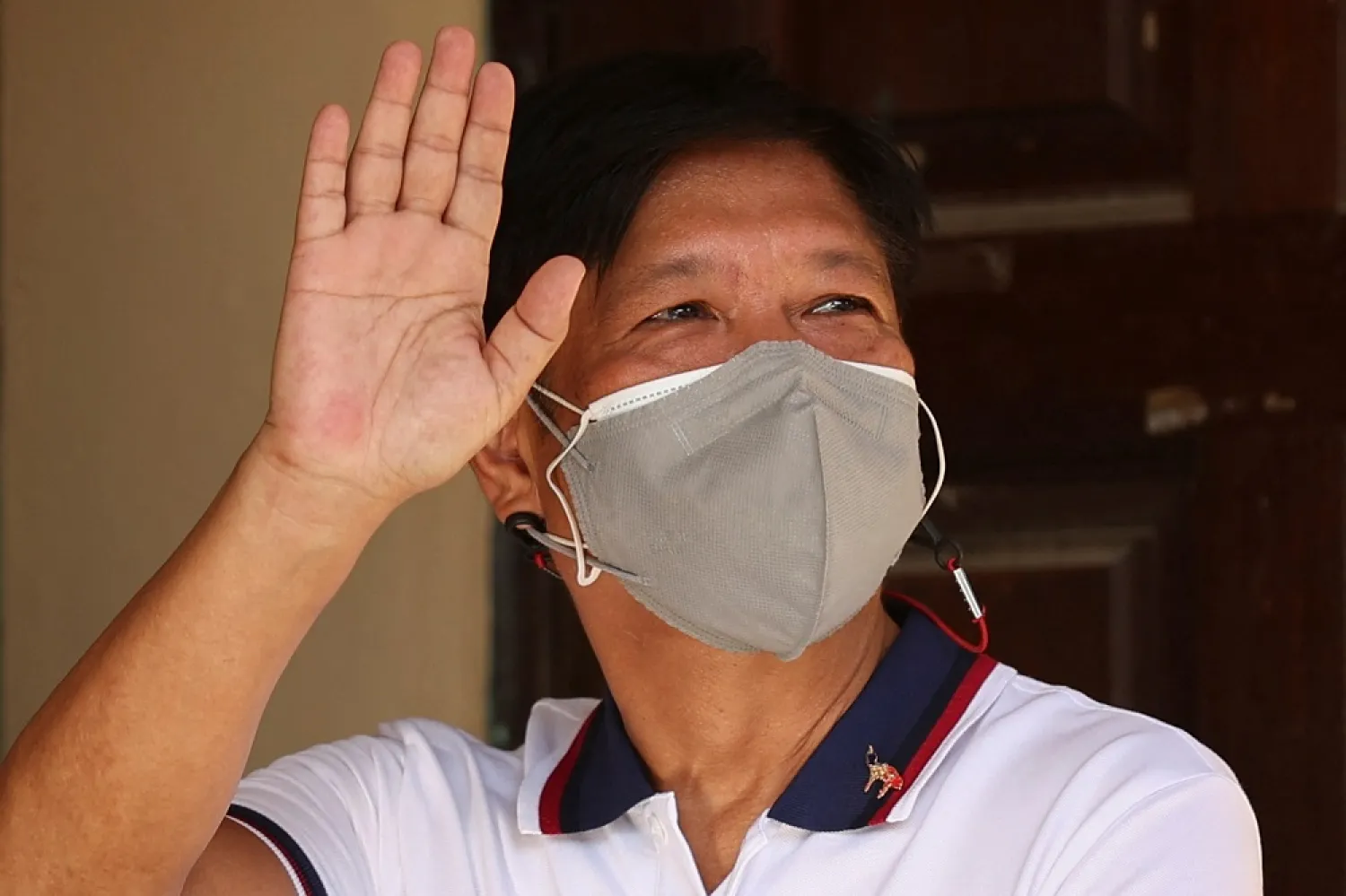 Ferdinand "Bongbong" Marcos Jr., the son and namesake of the late dictator, waves after casting his vote in the 2022 national elections at Mariano Marcos Memorial Elementary School in Batac, Ilocos Norte, Philippines, May 9, 2022. (Reuters)