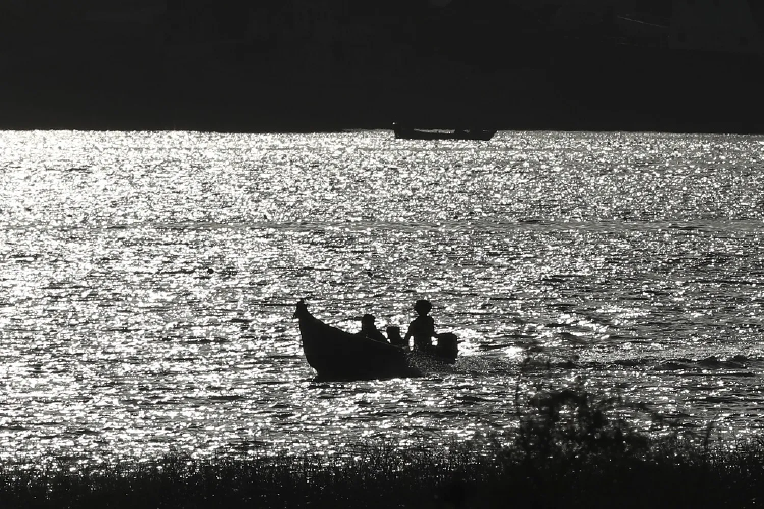 A boat sails as the sun sets over Shatt al-Arab waterway, Basra, Iraq, Monday, May 9, 2022. (AP)