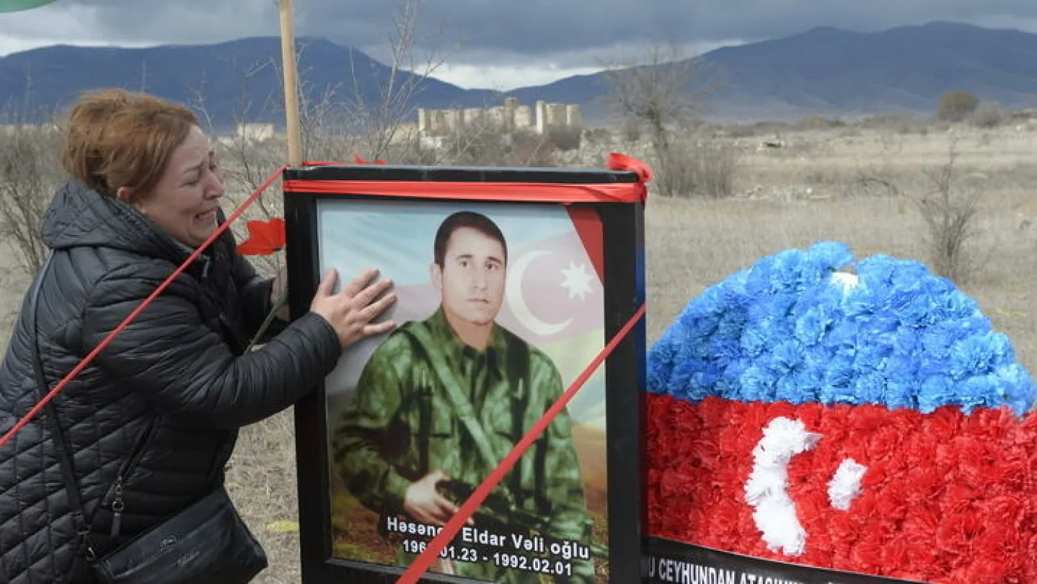 Painful return: Gulbeniz Jafarova, 55, cries at the grave of her brother who died defending Aghdam from Armenian separatists, who held the city for three decades Tofik BABAYEV AFP
