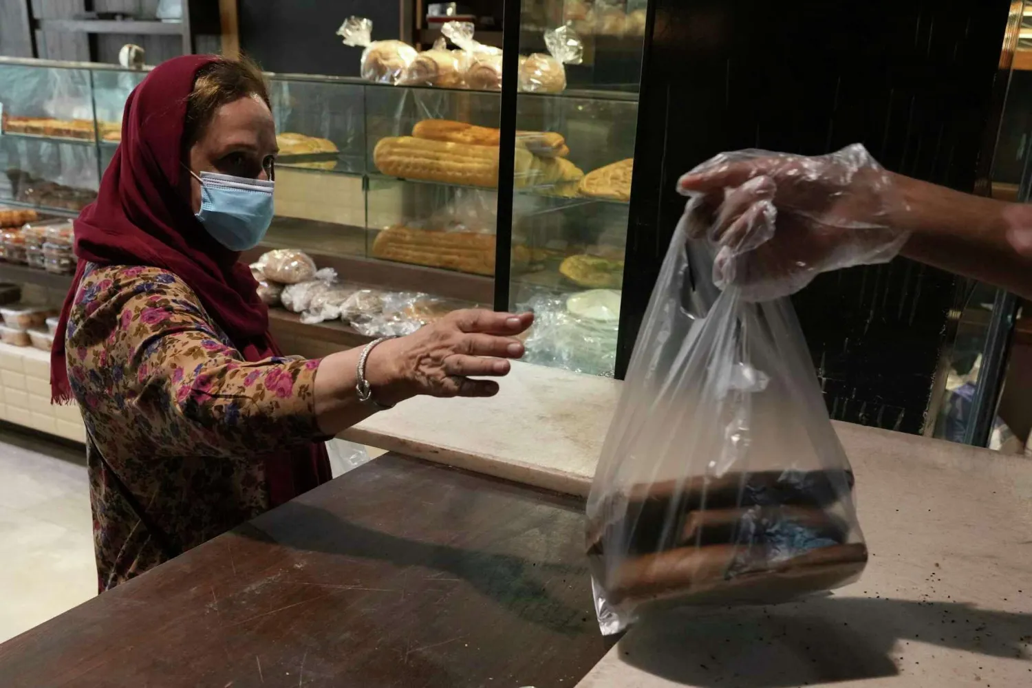A customer buys bread in a bakery in Tehran, Iran, Wednesday, May 11, 2022. Vahid Salemi/AP