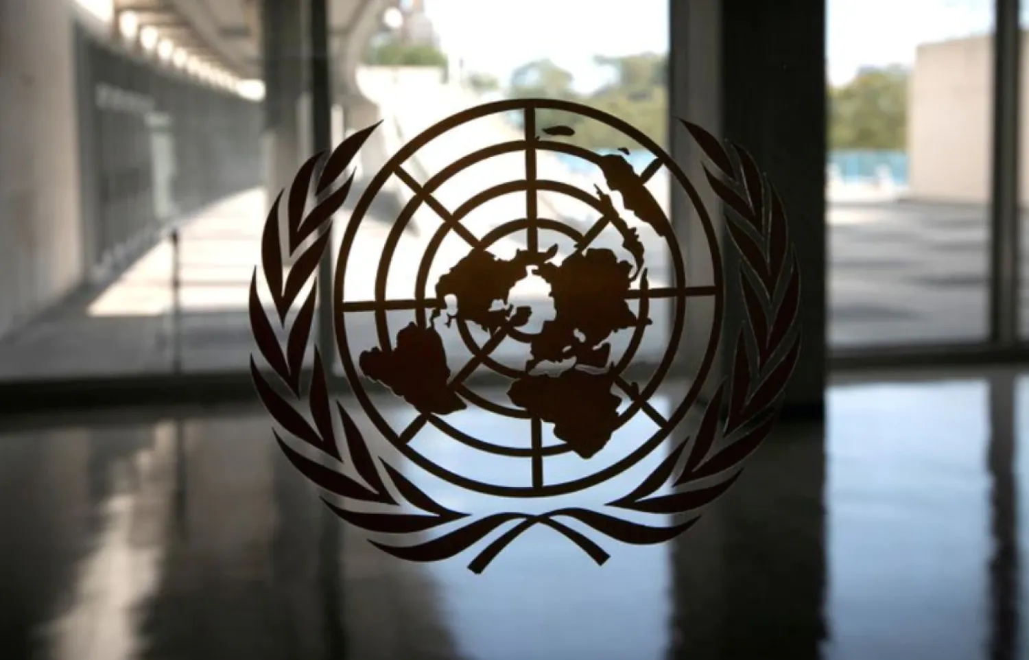 The United Nations logo is seen on a window in an empty hallway at United Nations headquarters during the 75th annual UN General Assembly high-level debate in New York, US, September 21, 2020. REUTERS/Mike Segar