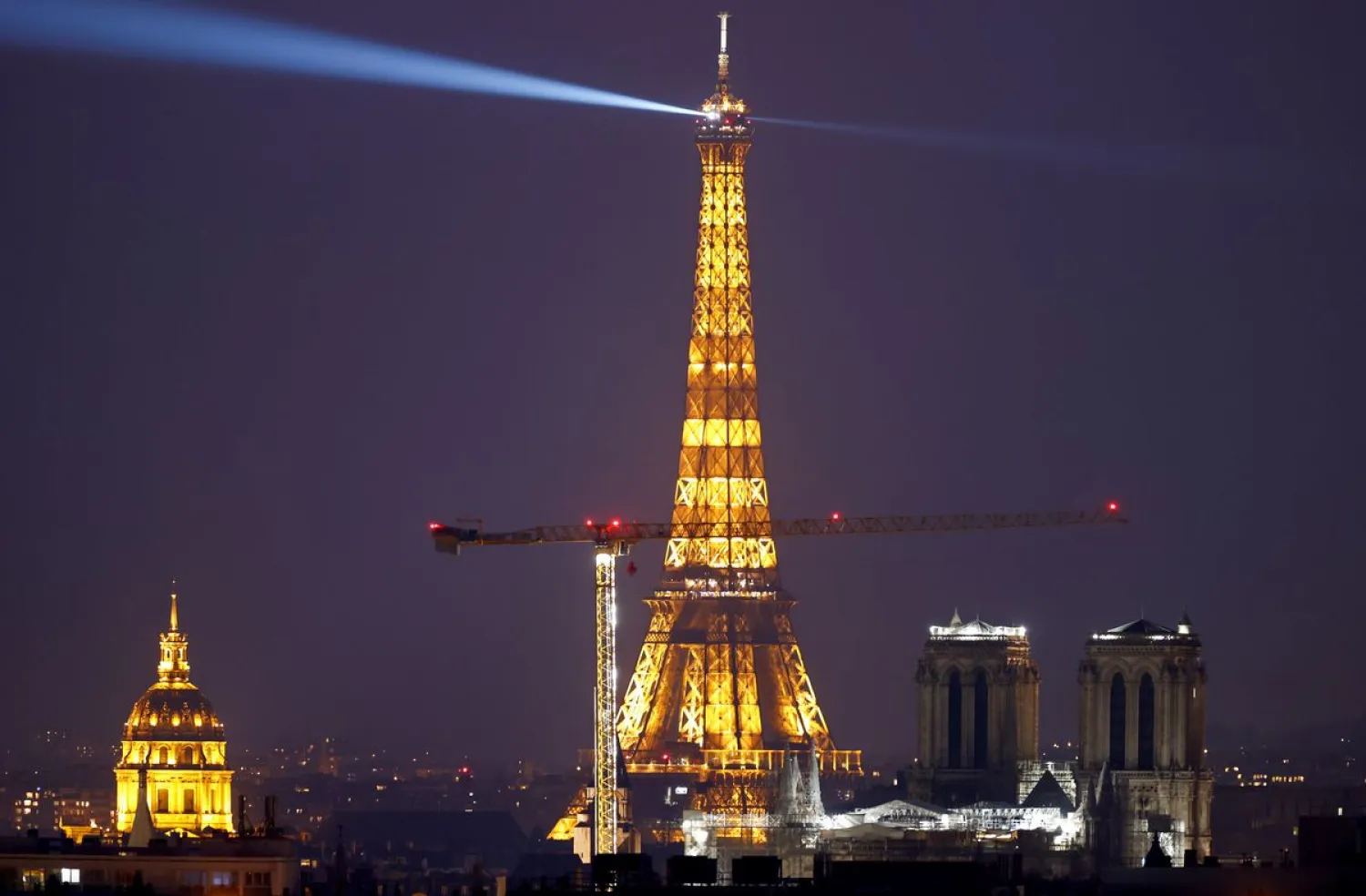 A general view shows Notre-Dame de Paris Cathedral, with the Eiffel Tower and the Dome des Invalides in Paris, France March 8, 2021. REUTERS/Christian Hartmann

