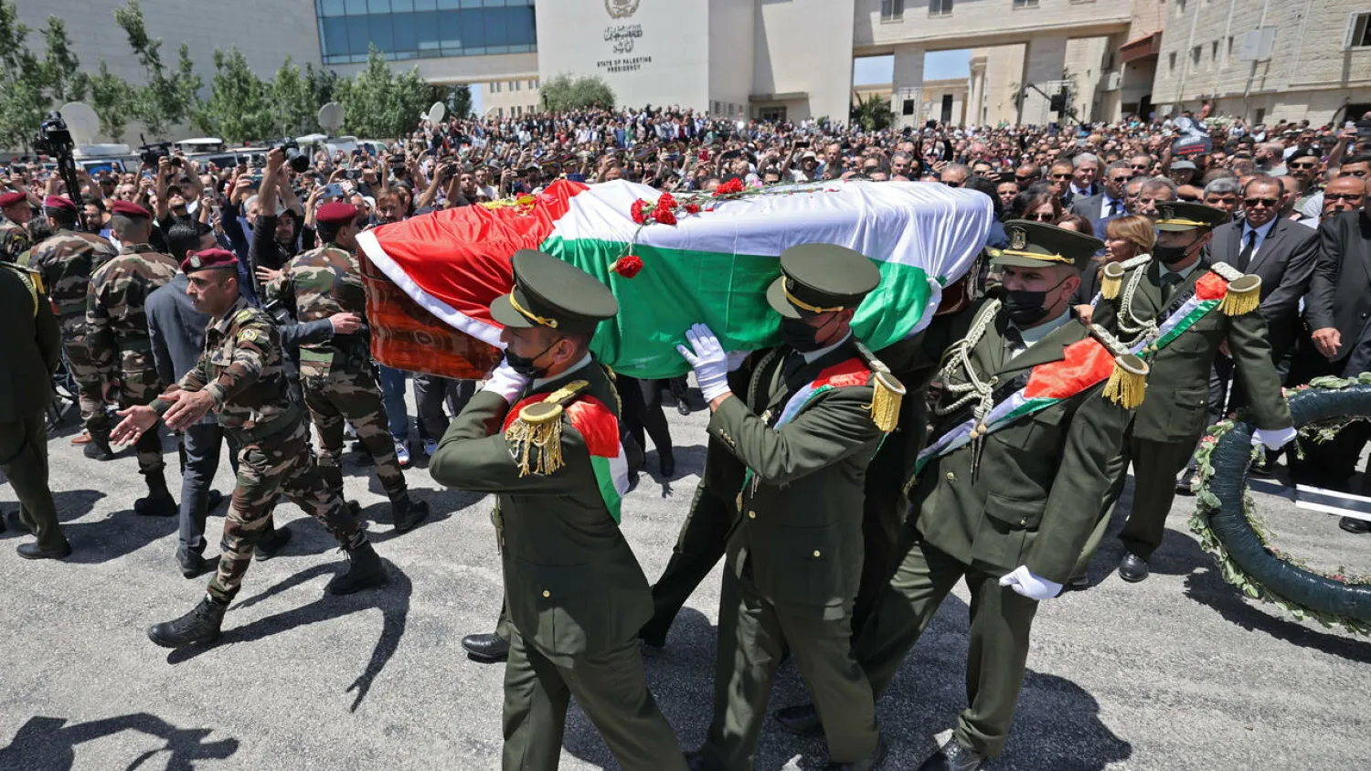 Palestinian honor guards carry the coffin of veteran Al Jazeera journalist Shireen Abu Akleh at the presidential headquarters in the West Bank city of Ramallah ABBAS MOMANI AFP
