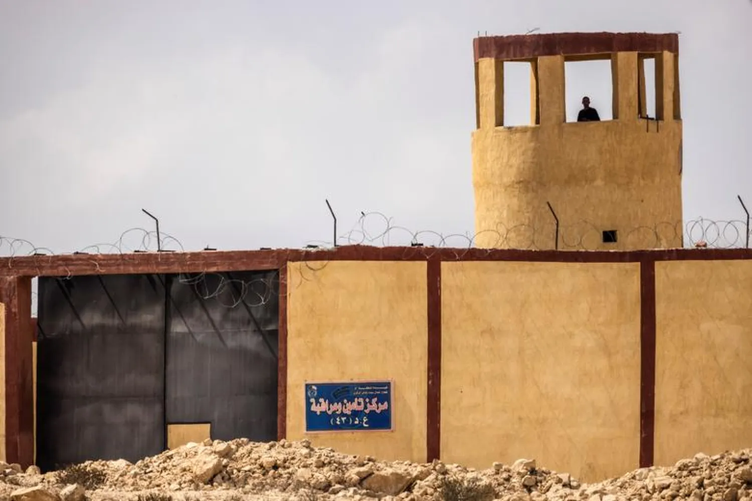 An Egyptian man stands guard in a military outpost overlooking the Israeli-Egyptian border as seen from southern Israel September 27, 2021. (Reuters)
