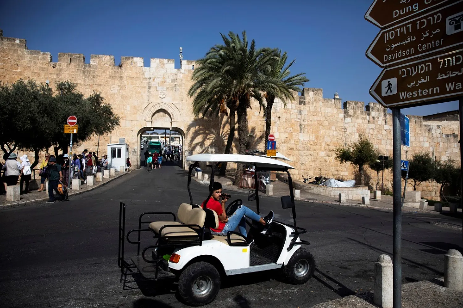 A man look on as he sits in a golf cart near Dung Gate, close to the Western Wall in Jerusalem's Old City November 7, 2019. (Reuters)