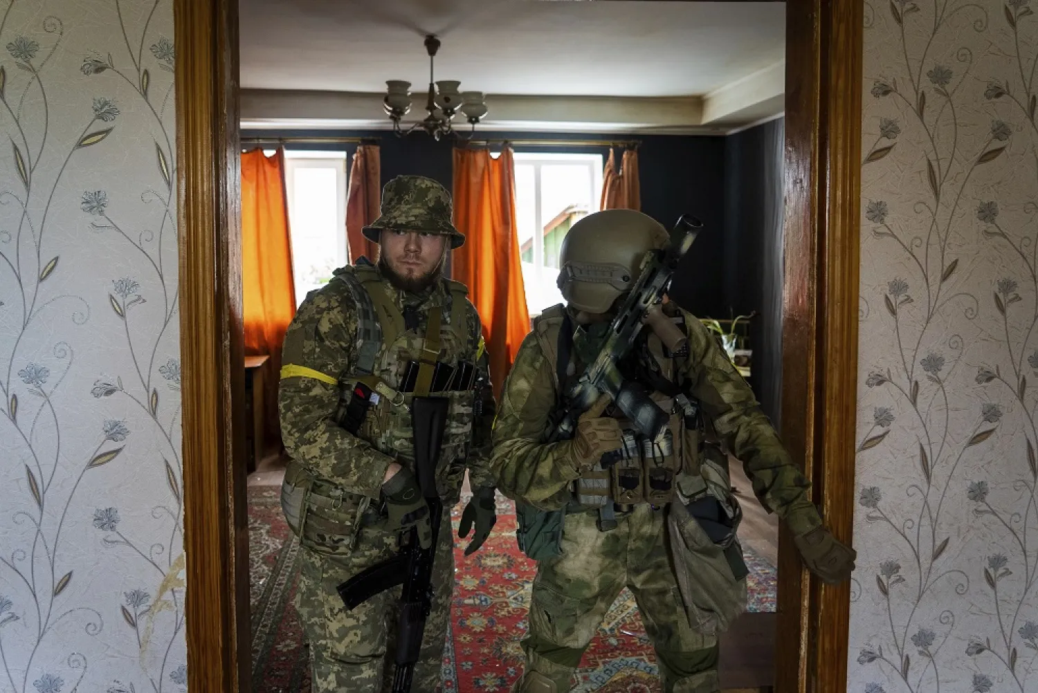 Ukrainian servicemen inspect a house during a reconnaissance mission in a recently retaken village on the outskirts of Kharkiv, east Ukraine, Saturday, May 14, 2022. (AP)