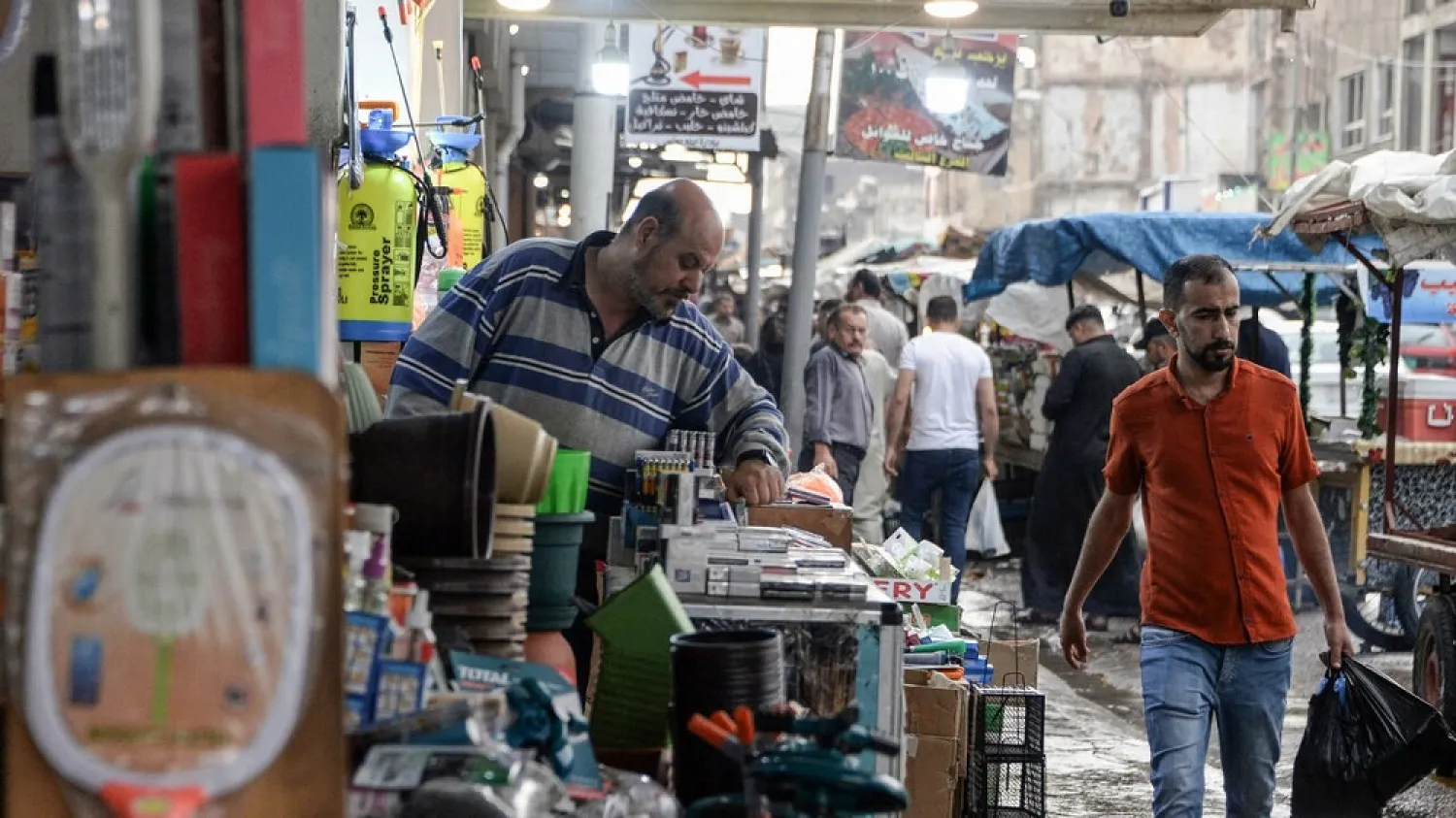 An Iraqi vendor organizes his stall in Mosul, part of Nineveh province where unemployment is around 40 percent. (AFP)