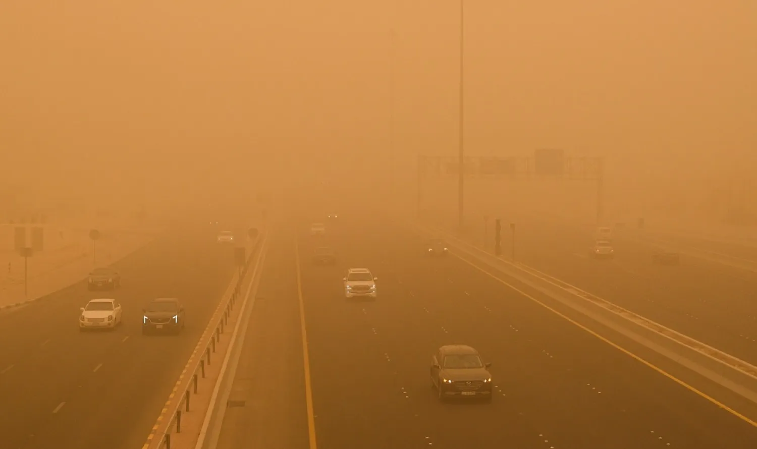  Vehicles transit at a road shrouded in heavy dust in Kuwait City, Kuwait, on 16 May 2022. (EPA)