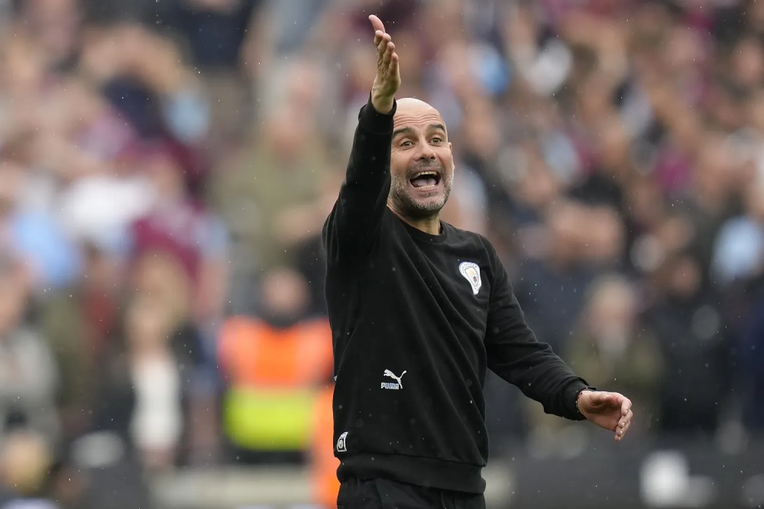 Manchester City's head coach Pep Guardiola reacts during the English Premier League match between West Ham United and Manchester City at London stadium in London, Sunday, May 15, 2022. (AP)