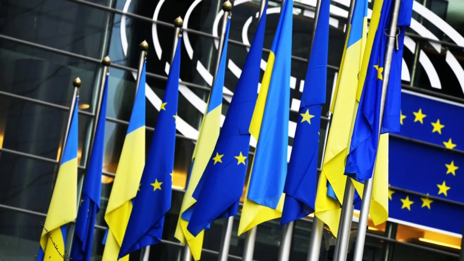 Ukrainian and European Union flags hang together on the exterior of the building at the European Parliament in Brussels. (AP)