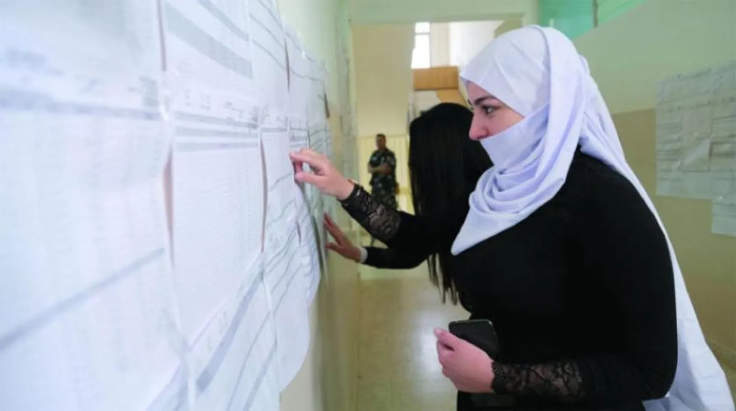 Şuf’ta bir seçmen, oy kullanma listesinde ismini arıyor (Reuters)