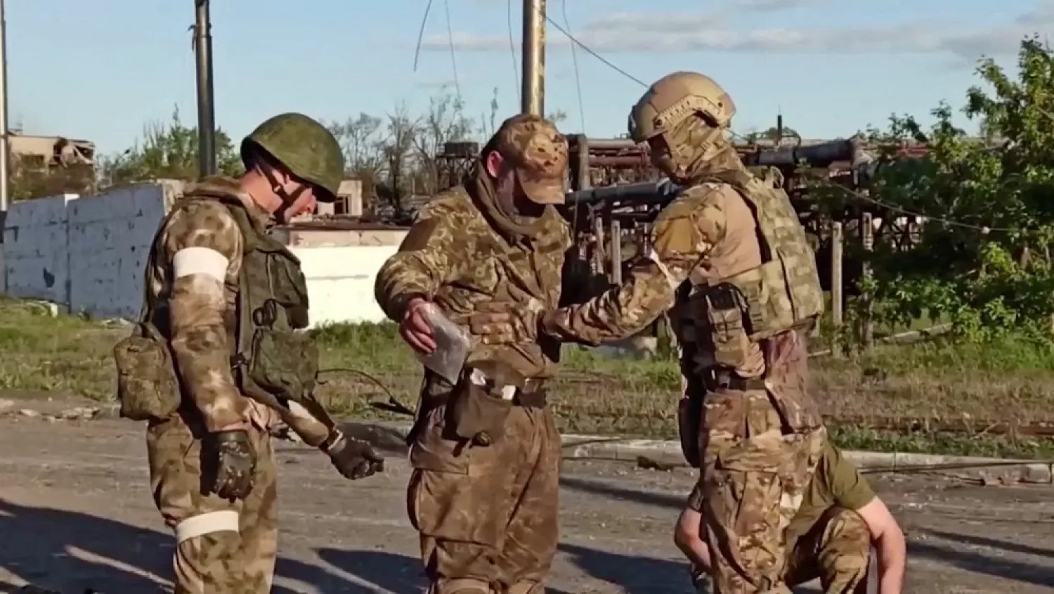 A still image taken from a video released by Russian Defense Ministry shows what it claims is a service member of Ukrainian forces, who left the besieged Azovstal steel plant, being searched by the pro-Russian military in Mariupol, Ukraine. Video released May 17, 2022. (Russian Defense Ministry/Handout via Reuters)