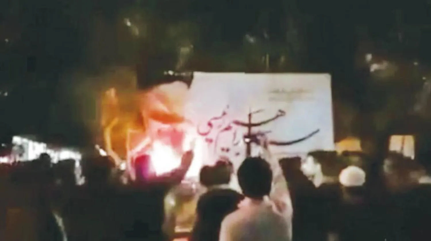 Protesters set fire to a banner of the Iranian president in the city of Hafshejan, Chaharmahal and Bakhtiari province, on Saturday evening. (Social media)