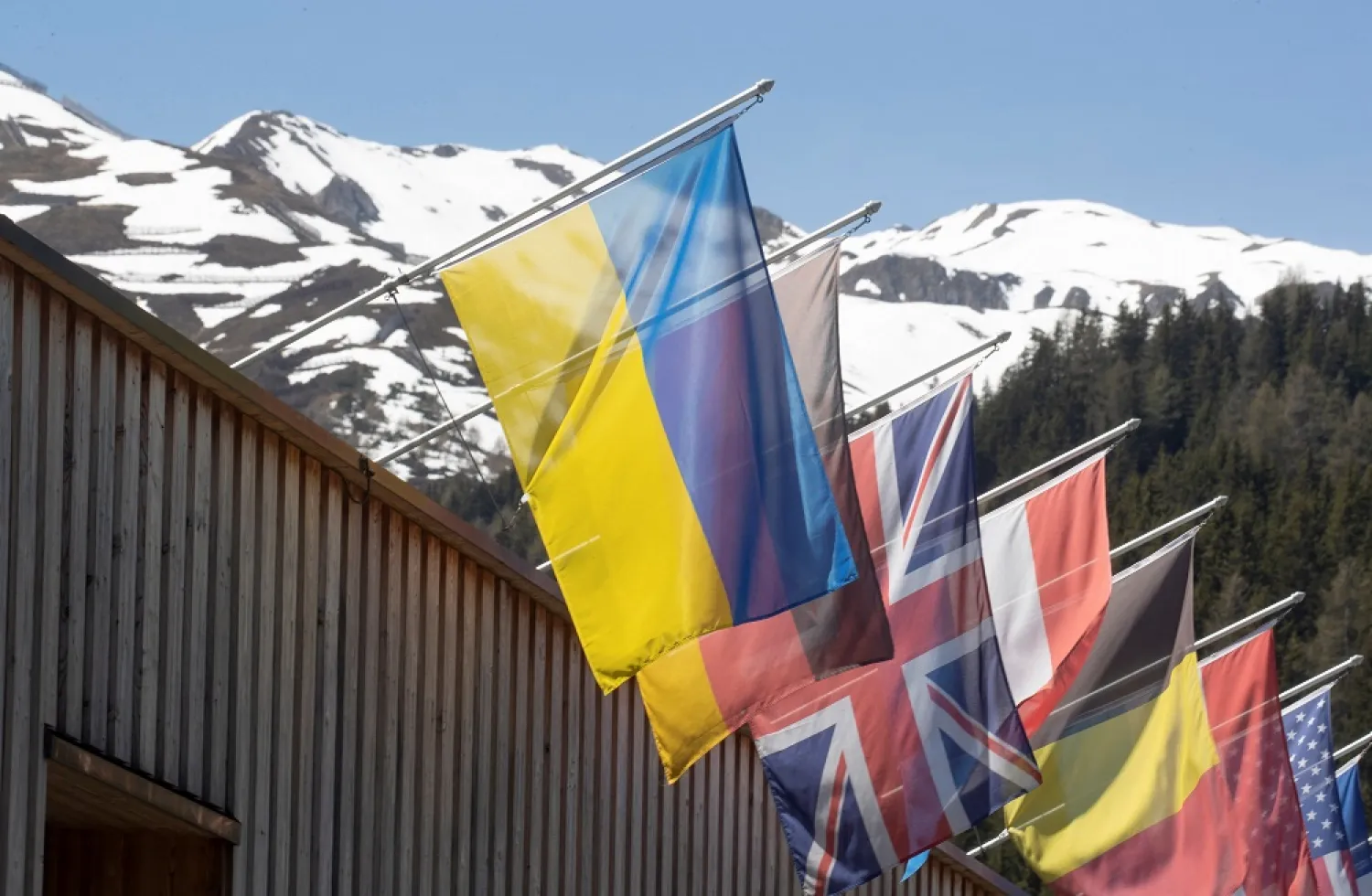 The national flag of Ukraine flies along with other countries' flags at the congress center, the venue of the upcoming World Economic Forum 2022 (WEF) in the Alpine resort of Davos, Switzerland May 11, 2022. Picture taken May 11, 2022. (Reuters)