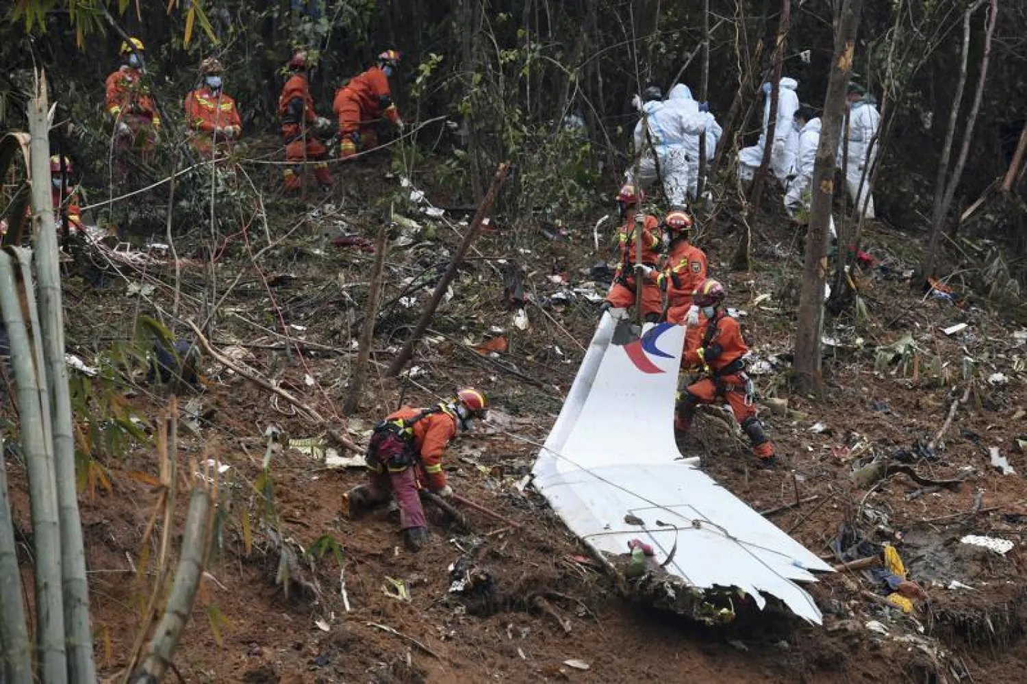 FILE - In this photo released by Xinhua News Agency, workers search through debris at the China Eastern flight crash site in Tengxian County in southern China's Guangxi Zhuang Autonomous Region on Thursday, March 24, 2022. (Lu Boan/Xinhua via AP, File)