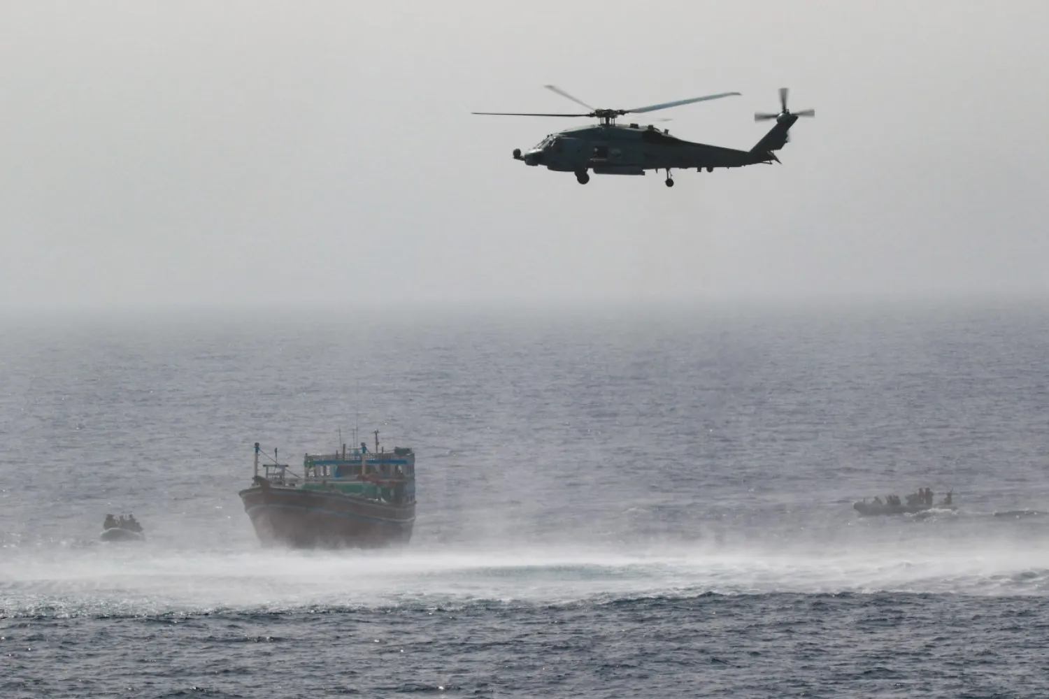 A US helicopter hovering above an Iranian fishing boat in the Gulf of Oman (US Navy)