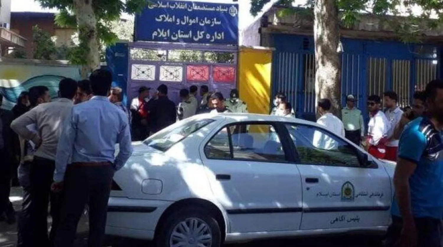 Police and civilians are seen outside the offices of the Foundation of the Oppressed. Mehr News agency