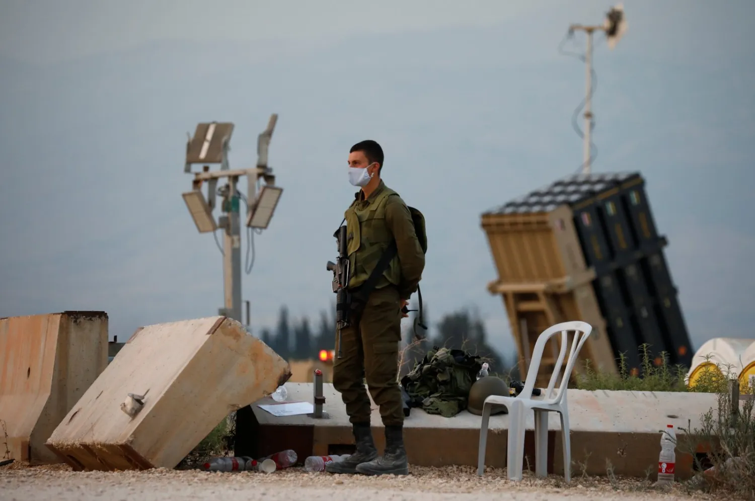 An Israeli soldier stands guard next to an Iron Dome anti-missile system near Israel's northern border with Lebanon, July 27, 2020. Reuters
