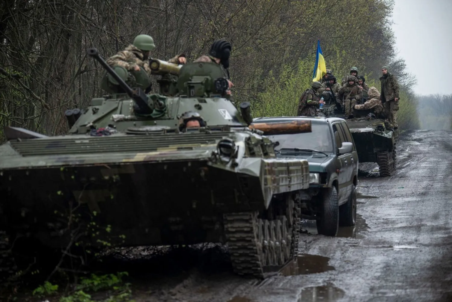 Ukrainian servicemen sit atop an armored fighting vehicle, as Russia's attack on Ukraine continues, at an unknown location in Eastern Ukraine, in this handout picture released April 19, 2022. Press service of the Ukrainian Ground Forces/Handout via REUTERS

