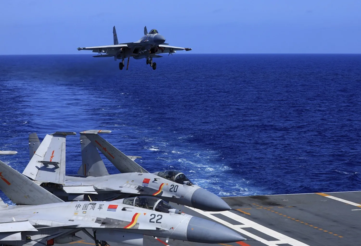 In this photo released Dec. 31, 2021, by Xinhua News Agency, an undated photo shows a carrier-based J-15 fighter jet preparing to land on the Chinese navy's Liaoning aircraft-carrier during open-sea combat training. (Xinhua via AP)
