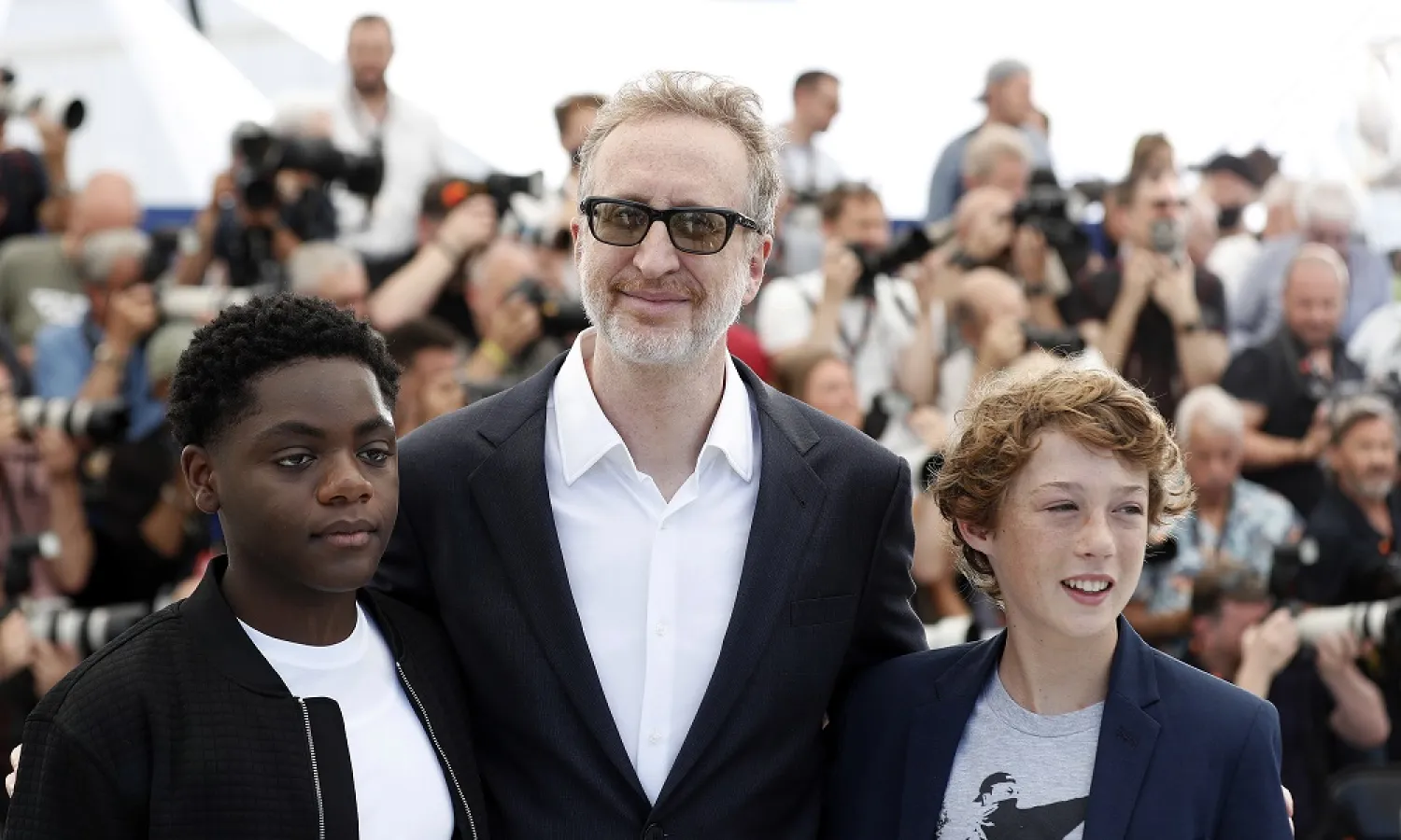 (R-L) Michael Banks Repeta, James Gray, and Jaylin Webb attend the photocall of 'Armageddon Time' during the 75th annual Cannes Film Festival, in Cannes, France, 20 May 2022. (EPA)