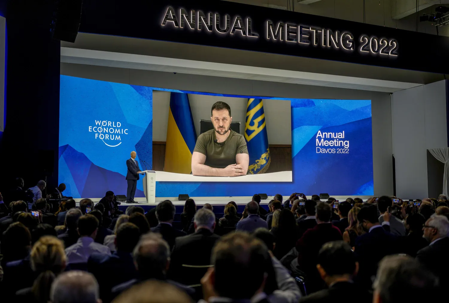 Ukrainian President Volodymyr Zelenskyy displayed on a screen as he addresses the audience from Kyiv on a screen during the World Economic Forum in Davos, Switzerland, Monday, May 23, 2022. The annual meeting of the World Economic Forum is taking place in Davos from May 22 until May 26, 2022. (AP Photo/Markus Schreiber)
