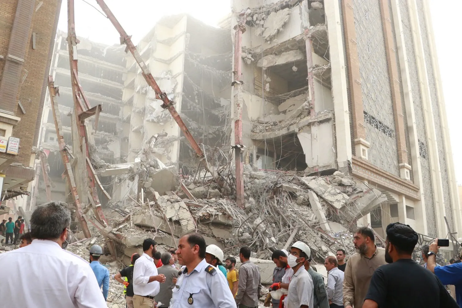 Iranians gather at the site of a ten-storey building collapse in Abadan, Iran May 23, 2022. (West Asia News Agency via Reuters)