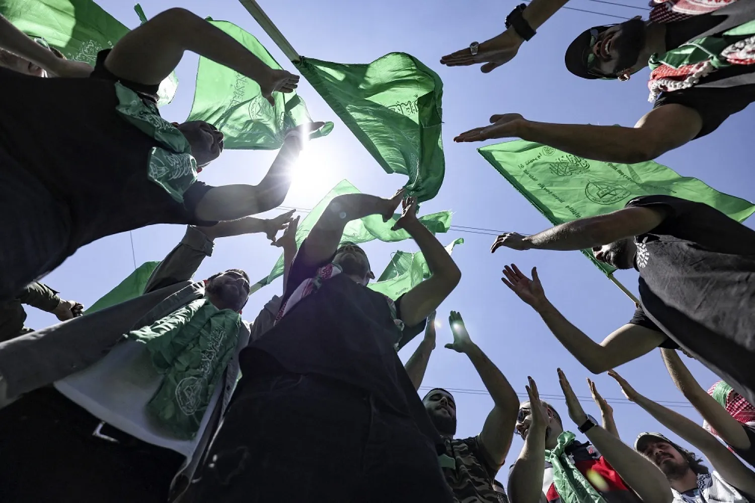 Palestinian students supporting the Hamas movement wave the movement's flag as they celebrate a victory in student elections at Birzeit University on the outskirts of Ramallah in the occupied West Bank on May 19, 2022. (AFP)