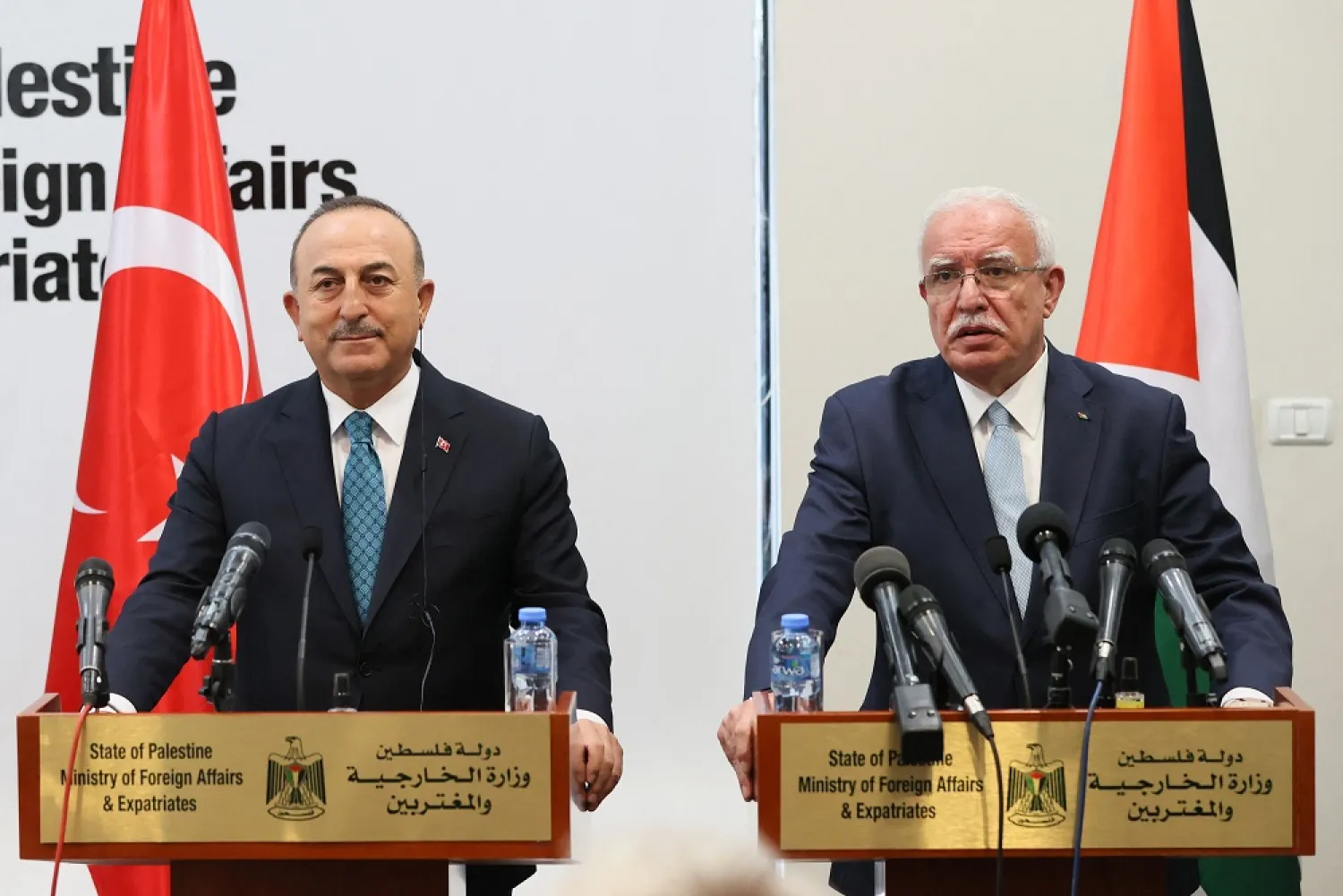 A handout picture taken and released by the Press office of the Turkish Ministry of Foreign Affairs on May 24, 2022 shows Turkish Foreign Minister Mevlut Cavusoglu (L) and Palestinian Foreign Minister Riad al-Maliki giving a press conference in the city of Ramallah in the occupied West Bank. (Turkish Foreign Minister Press Office/AFP)