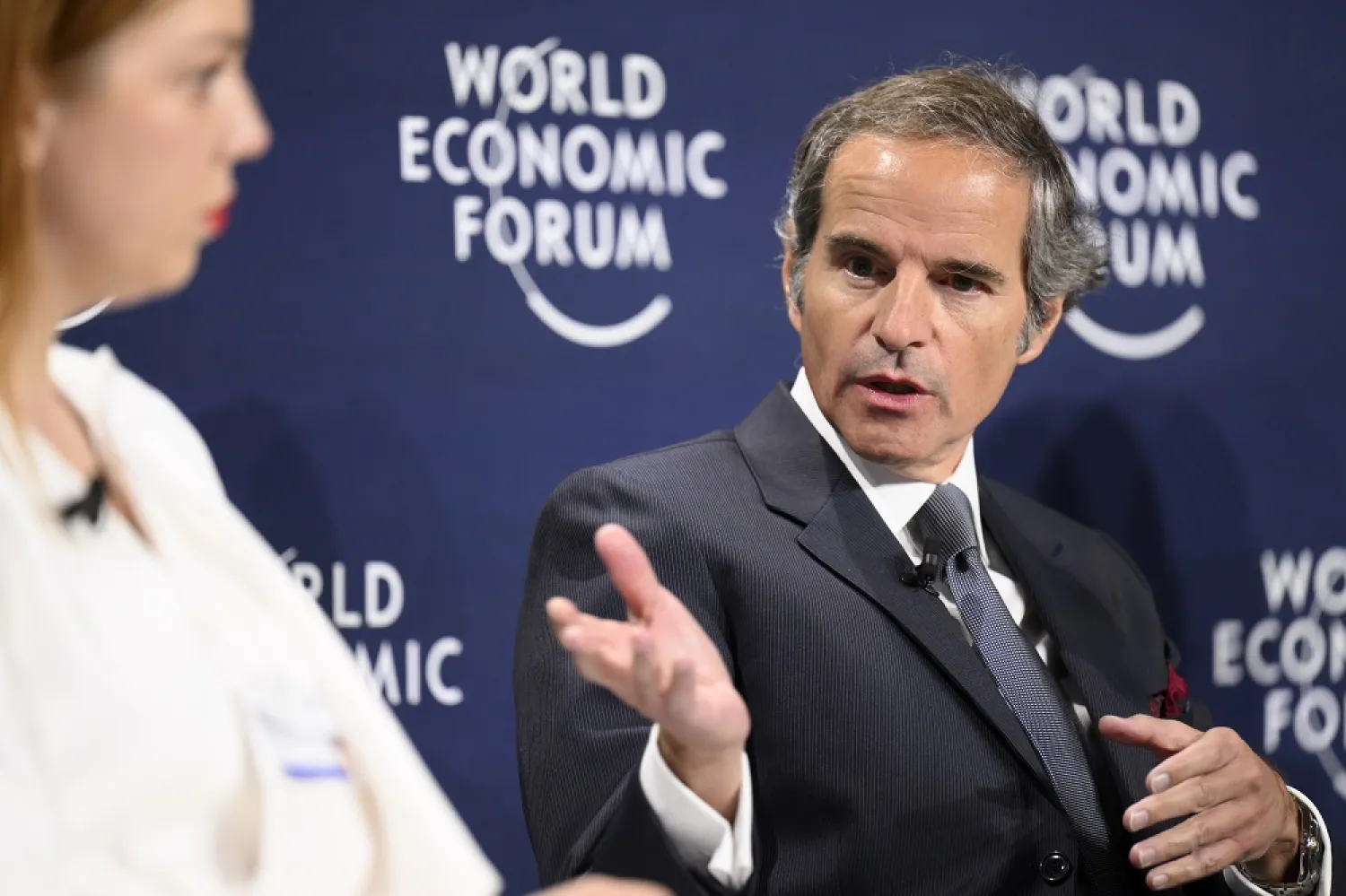 Alona Shkrum, Member of Parliament (Verkhovna Rada) of Ukraine, left, listens to Rafael Mariano Grossi, Director-General, International Atomic Energy Agency (IAEA), at the 51st annual meeting of the World Economic Forum, WEF, in Davos, Switzerland, Wednesday, May 25, 2022. (AP) 