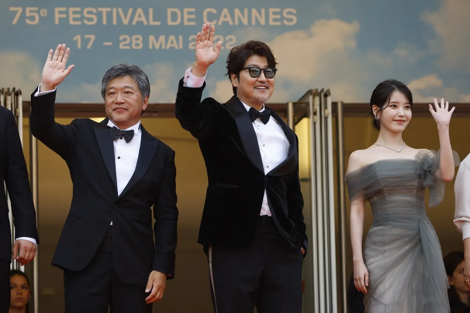 The 75th Cannes Film Festival - Screening of the film "Broker" (Les bonnes etoiles) in competition - Red Carpet Arrivals - Cannes, France, May 26, 2022. Director Hirokazu Kore-eda, cast members Song Kang-Ho and Lee Ji-eun (known as IU) pose. (Reuters)