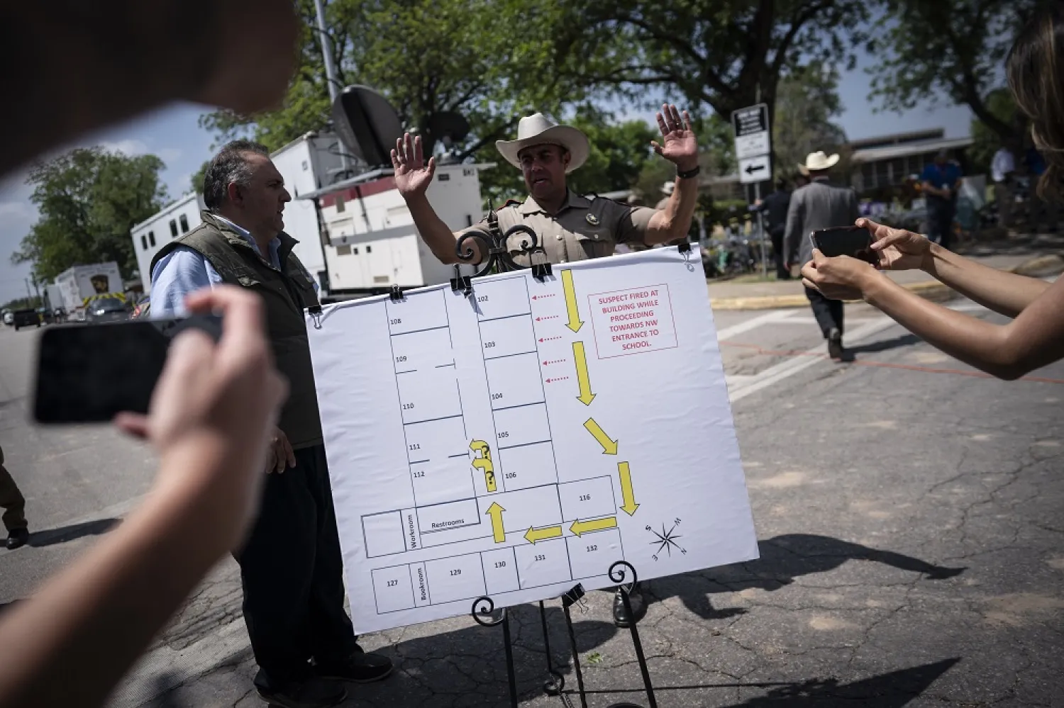 Members of the media take photos of a map of the school which was used a press conference held outside Robb Elementary School on Friday, May 27, 2022, in Uvalde, Texas. (AP)
