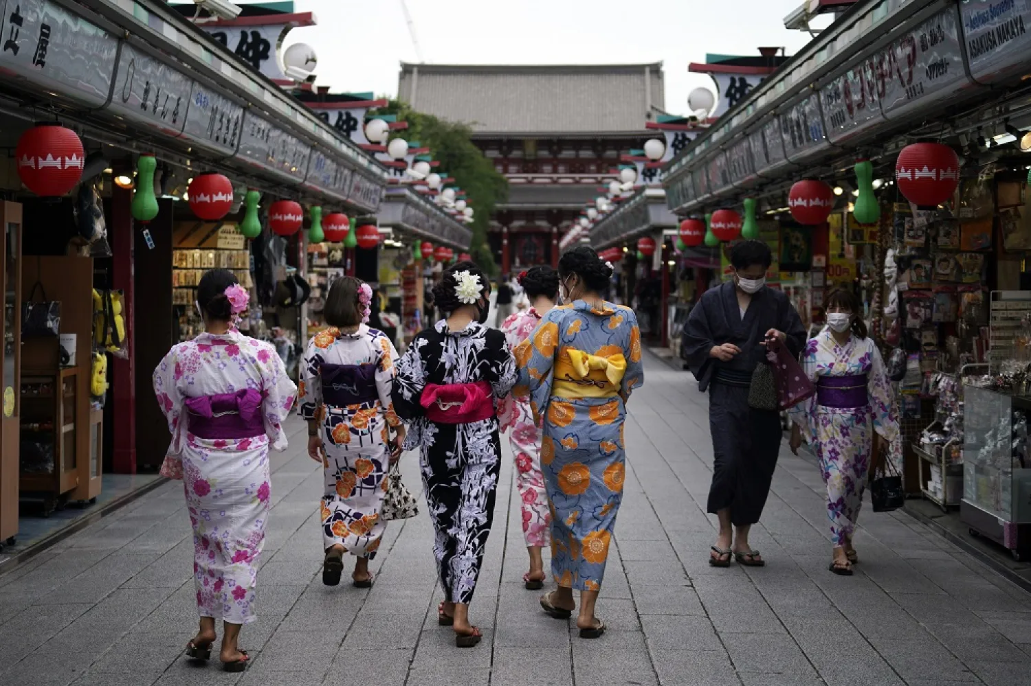 Tourists in traditional Japanese kimonos walk in Asakusa district in Tokyo, July 27, 2020. (AP)
