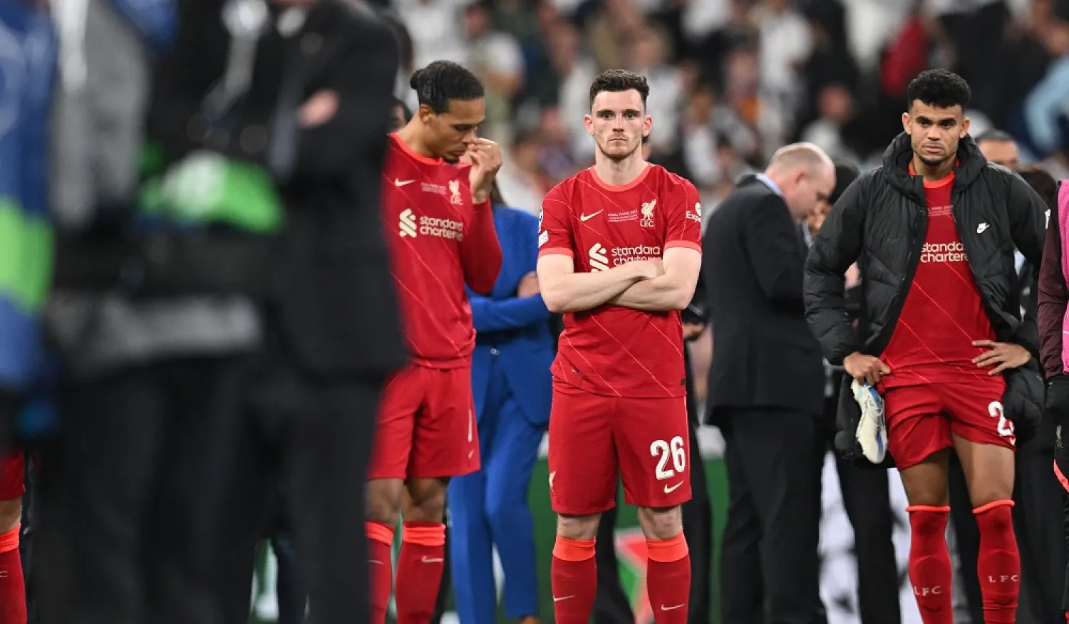 Liverpool's Scottish defender Andrew Robertson (C) reacts on the pitch after Madrid 's victory in the UEFA Champions League final football match between Liverpool and Real Madrid at the Stade de France in Saint-Denis, north of Paris, on May 28, 2022. (AFP)