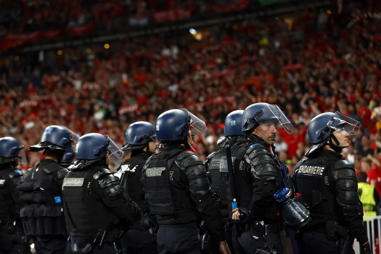 French riot police in front of Liverpool supporters at the end of the UEFA Champions League final between Liverpool FC and Real Madrid at Stade de France in Saint-Denis, near Paris, France, 28 May 2022. (EPA)