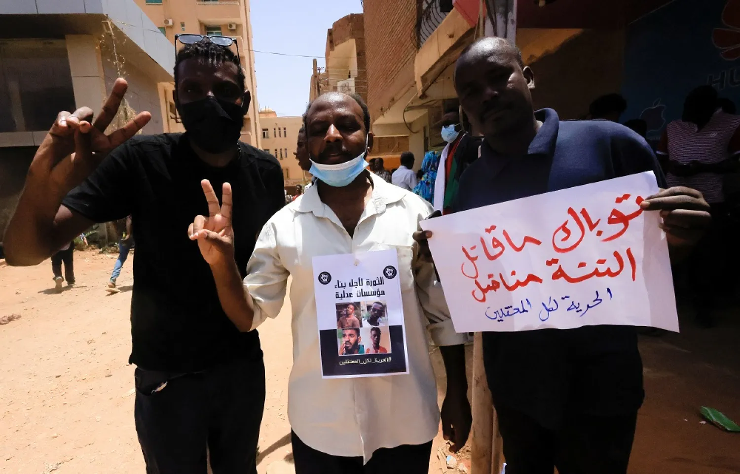 Demonstrators who have gathered outside the court gesture during the procedural session of the trial of demonstrators accused of killing a police brigadier, in Khartoum, Sudan May 29, 2022. (Reuters)