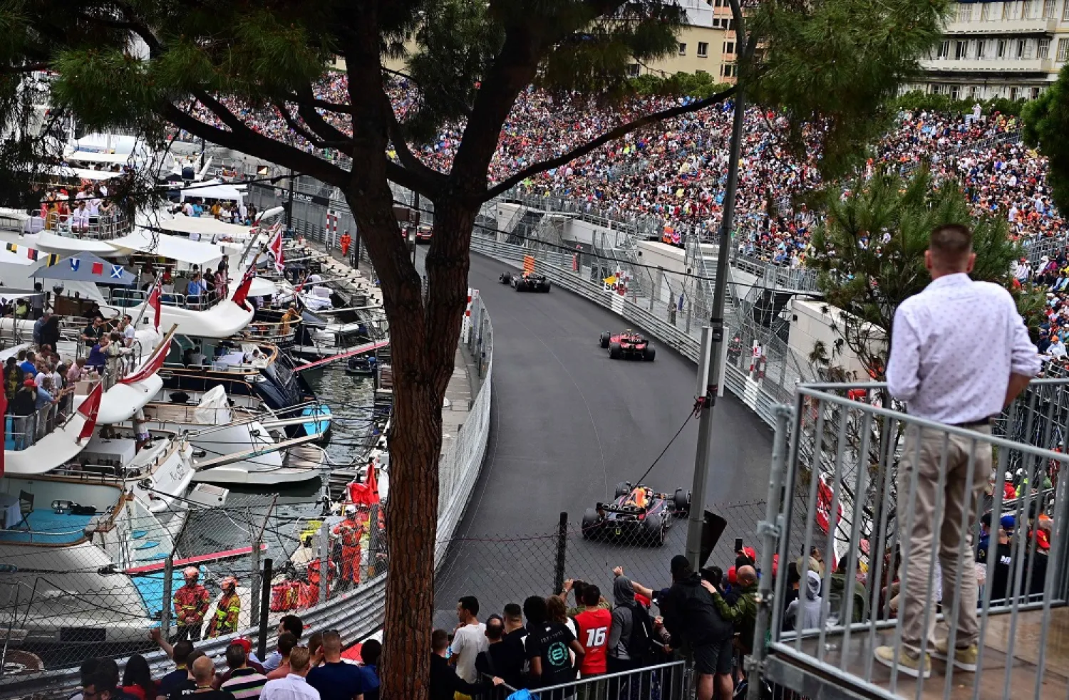Red Bull Racing's Dutch driver Max Verstappen (down), Ferrari's Spanish driver Carlos Sainz Jr (C) and Red Bull Racing's Mexican driver Sergio Perez (up) compete in the Monaco Formula 1 Grand Prix at the Monaco street circuit in Monaco, on May 29, 2022. (AFP)