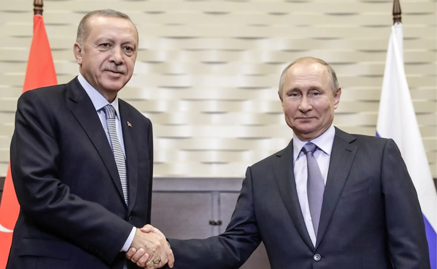 22 October 2019, Russia, Sochi: Russian President Vladimir Putin (R) shakes hands with Turkish President Recep Tayyip Erdogan during a meeting. (Kremlin/dpa)