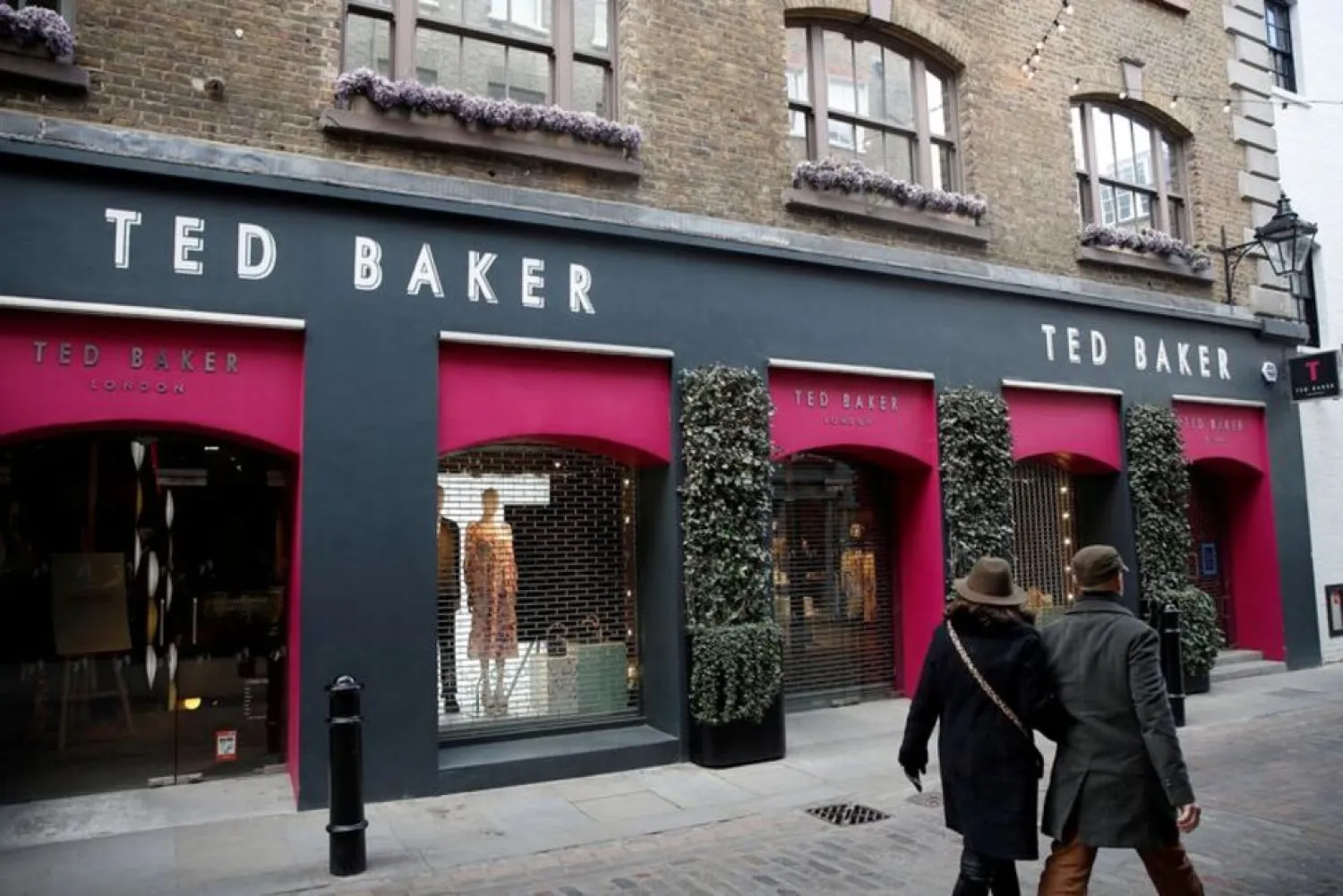 People walk past a Ted Baker store on Floral Street, in London, Britain, April 3, 2022. Picture taken April 3, 2022. (Reuters)
