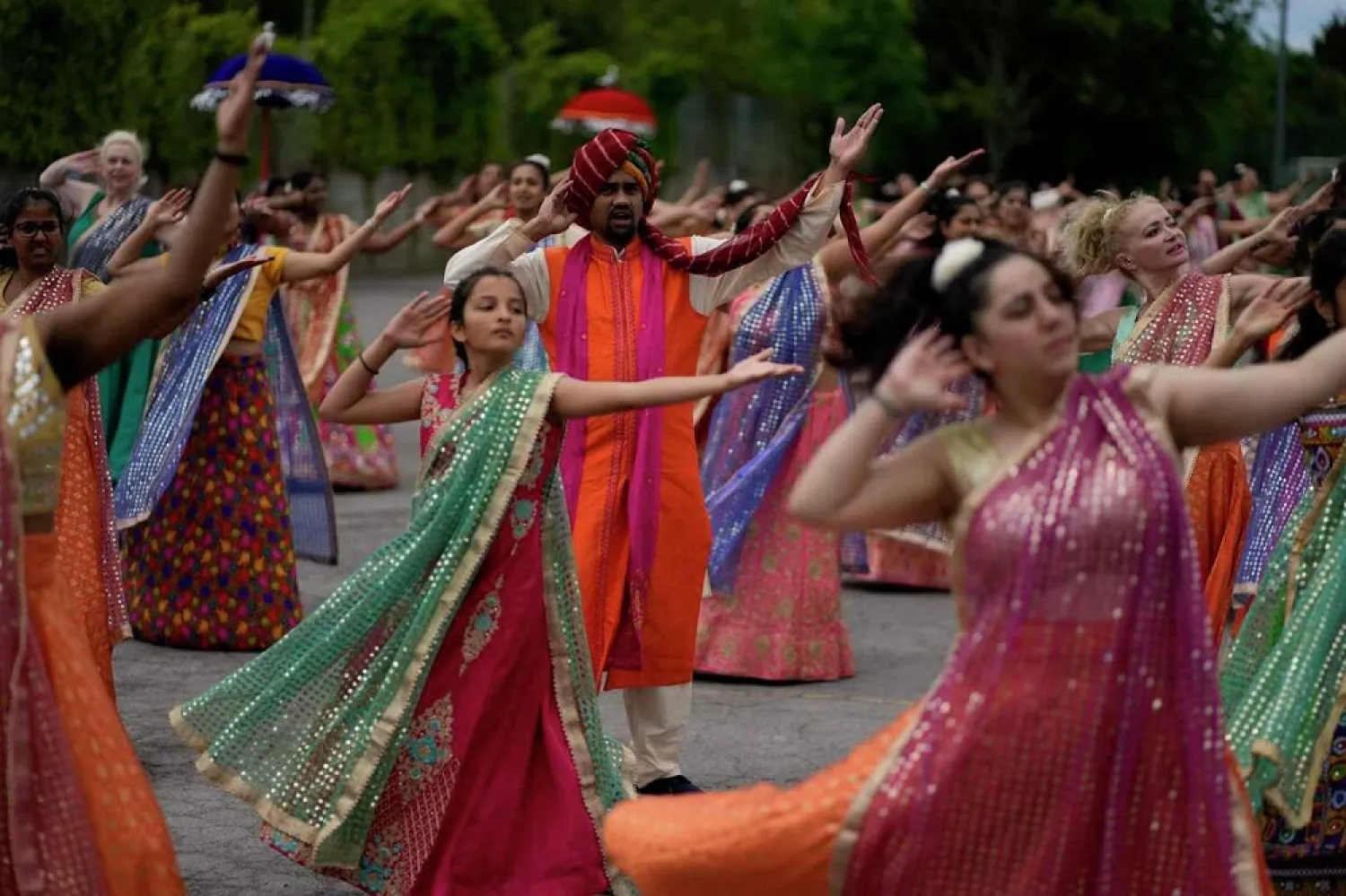 Performers take part in a rehearsal for the Nutkhut creative company ahead of their upcoming Bollywood style performance entitled "The Wedding Party", which will be part of the procession at the Platinum Jubilee Pageant, at Northolt High School, in north west London, Sunday, May 29, 2022. (AP)