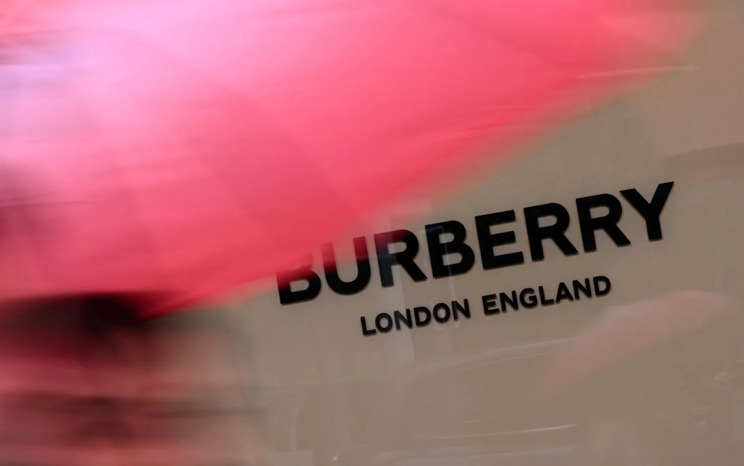 Pedestrians pass a storefront for fashion retailer Burberry in west London on May 15, 2022. (AFP) 