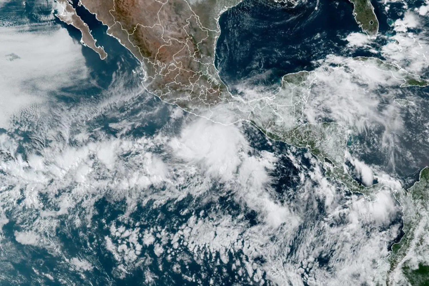 This satellite image made available by NOAA shows Hurricane Agatha, center, off the Pacific coast of Mexico on Sunday, May 29, 2022, at 11:20 a.m. EDT. (NOAA via AP)
