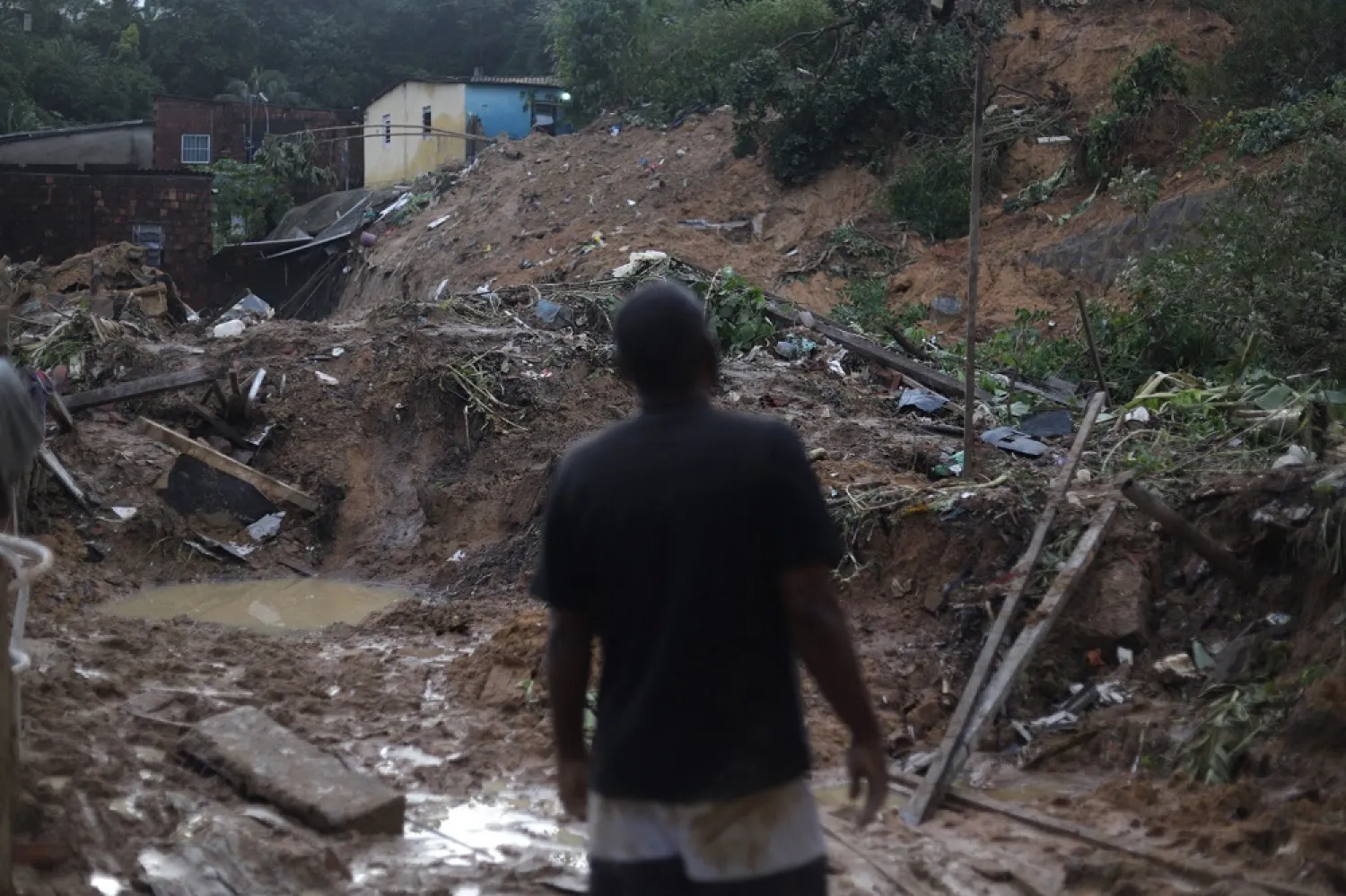 A man looks at the site of a landslide in the community Jardim Montes Verdes, Ibura neighborhood, in Recife, Pernambuco State, Brazil, on May 31, 2022. (AFP)