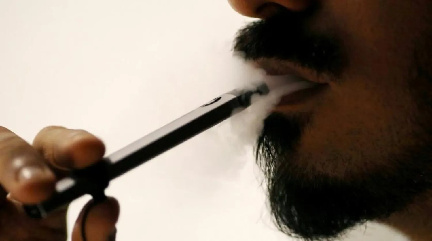 A man smokes an e-cigarette at a café in Dubai. Photo: Reuters
