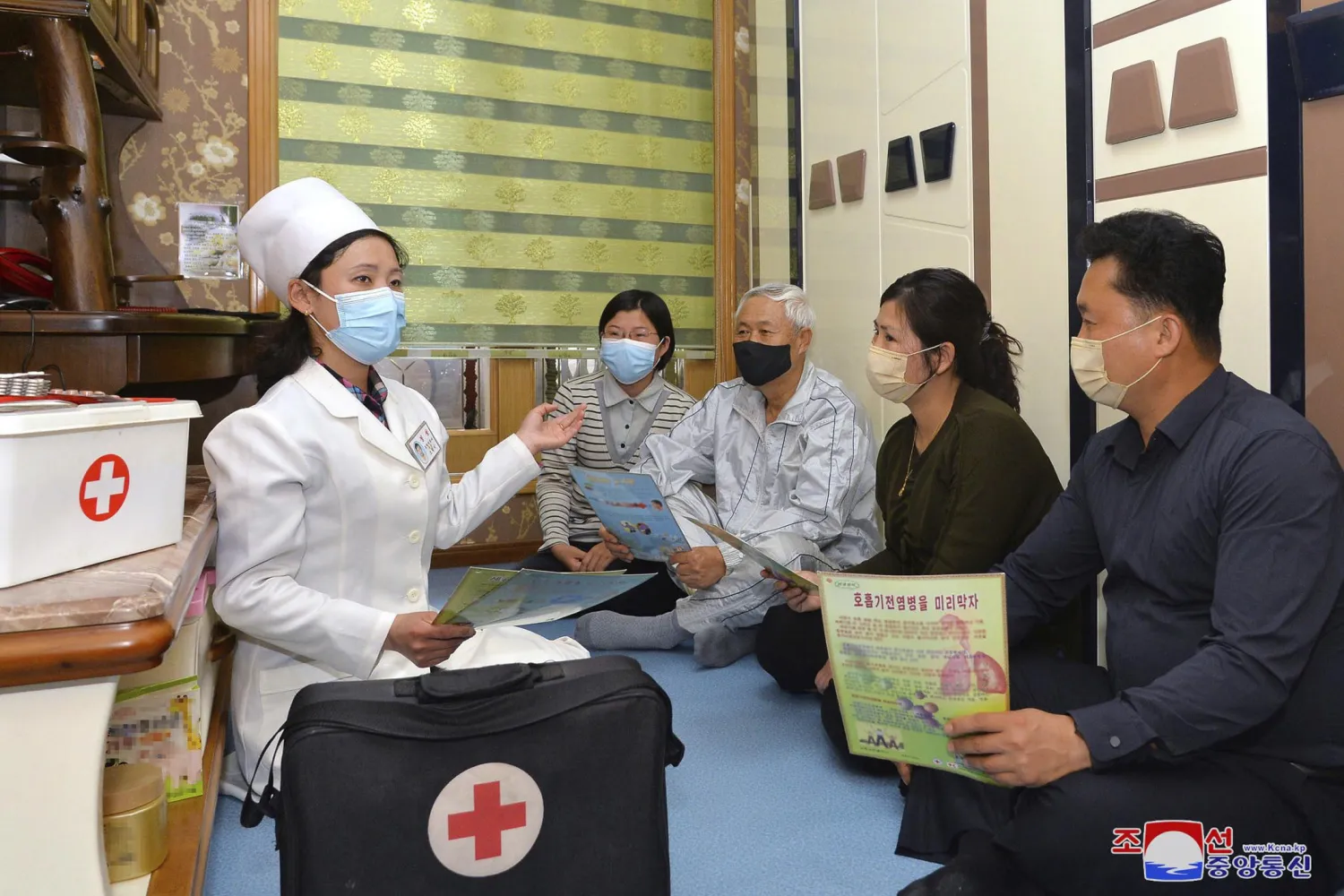In this photo provided by the North Korean government, a doctor visits a family during an activity to raise public awareness of the COVID-19 prevention measures, in Pyongyang, North Korea Tuesday, May 17, 2022. (Korean Central News Agency/Korea News Service via AP)