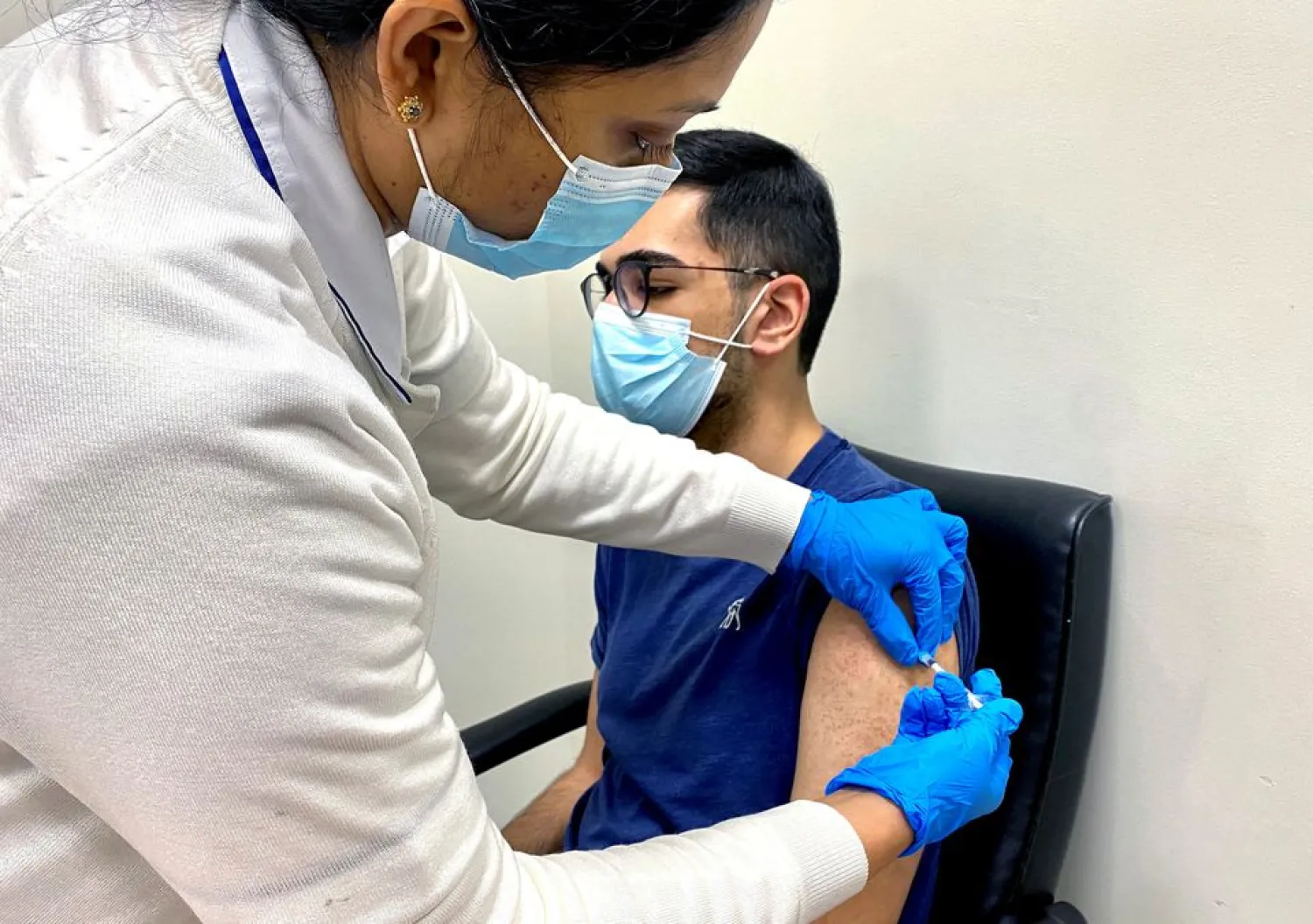 A man receives a dose of a vaccine against the coronavirus disease (COVID-19), in Dubai, United Arab Emirates December 28, 2020. REUTERS/Abdel Hadi Ramahi/File Photo