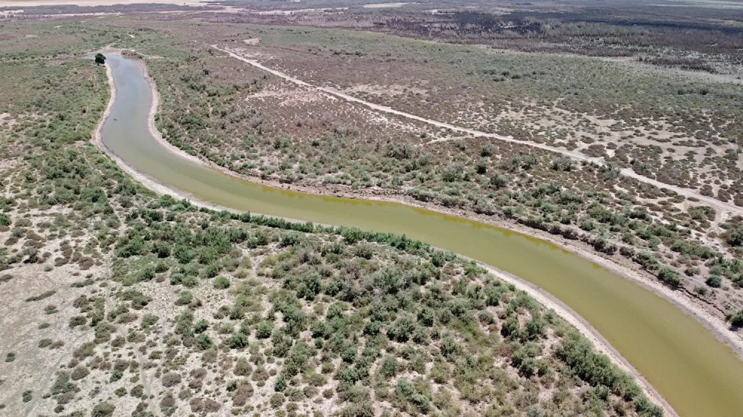 An aerial picture taken by drone shows receding waters due to drought at the Iraq's Al-Hawizeh Marsh on the southern border with Iran, on May 31, 2022. (AFP) 