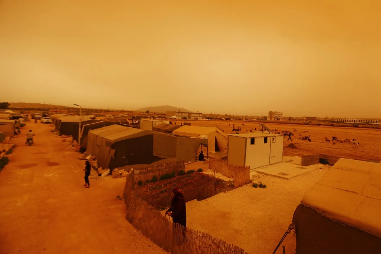  A general view shows a dust storm on the outskirts of the opposition-held town of Dana, in the northwestern Idlib province near the Turkish-Syrian border, on June 2, 2022. (AFP)